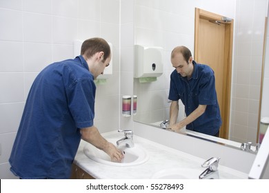 Man Washing Hands. Public Toilet