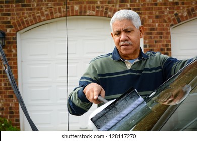 Man Washing His Car In The Driveway