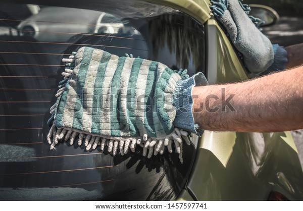 Man washing his green car - car washing and car
cleaning concept