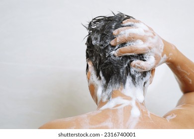 A man is washing his hair with shampoo - Powered by Shutterstock