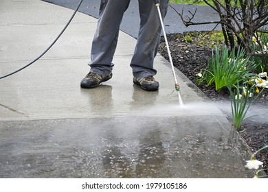 Man Washing Off Dirt. Person Uses Power Washer, Spring Cleaning. 