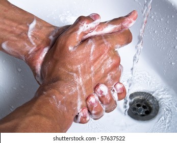 Man Washing Soapy Hands In Bathroom