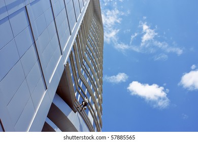 Man washing windows on high-rise building