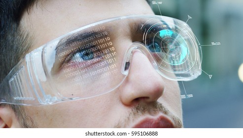 A man watches with a futuristic look with glasses augmented reality in holography. Concept: immersive technology, future, eyes, and futuristic vision. - Shutterstock ID 595106888
