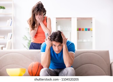 Man Watching Basketball With His Wife