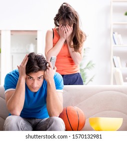 Man Watching Basketball With His Wife