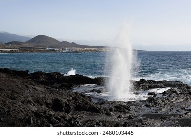 A man watching a blow hole at the coast - Powered by Shutterstock