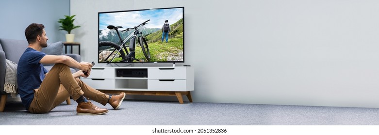 Man Watching Connected TV Screen In Living Room - Shutterstock ID 2051352836