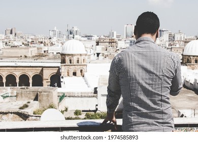 A Man Watching The Ez Zitouna Or Al Zaytuna Mosque In The Old City Of Tunis In A Cloudy Day.