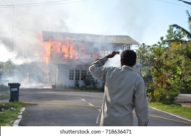 A Man Watching The House On Fire In Kuching, Sarawak, Malaysia