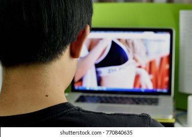 Man watching photo of sexy women on computer laptop.