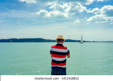 Man Watching Sailboats From The Coast At Balaton Lake Hungary