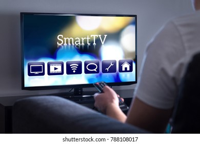 Man Watching Smart Tv. Choosing Movie Or Series From The Menu. Person Holding Remote Control. User Interface On Television Screen.