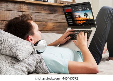 Man Watching Streaming Series In A Laptop Computer, Lying In The Bed At Home.