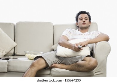 Man watching television on sofa