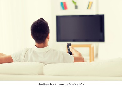 Man Watching Tv And Changing Channels At Home