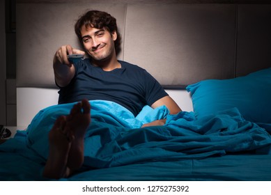 Man Watching Tv At Night In Bed