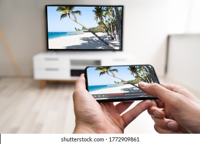 Man Watching TV Streaming From Smartphone Or Mobile Phone  - Shutterstock ID 1772909861