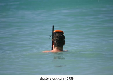 man in water with snorkel gear on