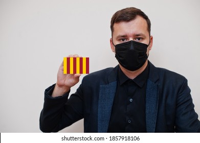 Man Wear Black Formal And Protect Face Mask, Hold Northumbria Flag Card Isolated On White Background. United Kingdom Territories Of England Coronavirus Covid Concept.