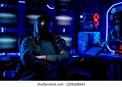 Man wear clothes look like hacker and sit with arm-crossed in room also in front of monitor show light with sign look fear and scary. Concept of safety for computor system and danger with hacker.