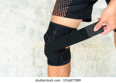 The man wear the Knee Support Brace Patella in the park - Knee Pads Hole Sports