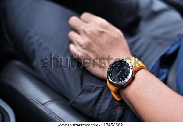 Man wear sports watch during\
driving in car,performance or heart rate pulse and training working\
out. Healthy lifestyle, sport and fitness outdoors in\
nature.