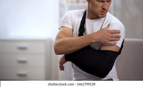 Man Wearing Arm Sling Feeling Pain In Shoulder, Result Of Trauma, Orthopedics