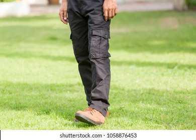 Man Wearing Black Cargo Pants And Standing In The Nature Park