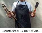 A man wearing black chef