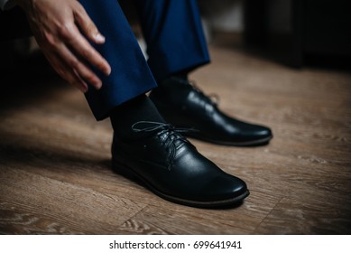 A man is wearing black shoes in close-up.