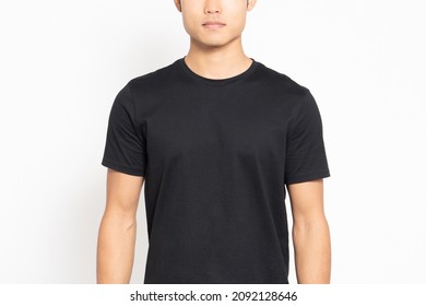 Man Wearing A Black Tee Shirt Standing In Front Of A White Background