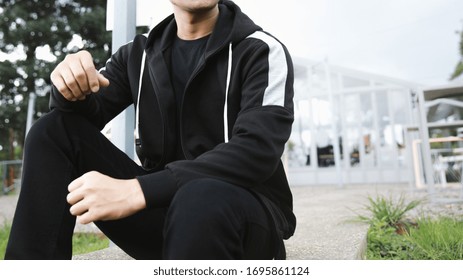 
Man Wearing Black Zipper Hoodie, In The Urban Background 