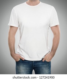Man wearing blank t-shirt isolated on gray background with copy space