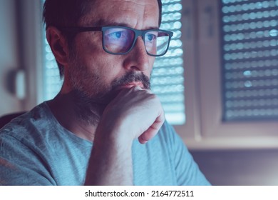 Man Wearing Blue Light Blocking Prescription Glasses While Looking At Computer Screen, Close Up Portrait With Selective Focus