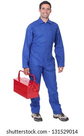 Man Wearing Blue Overalls Holding Tool Kit