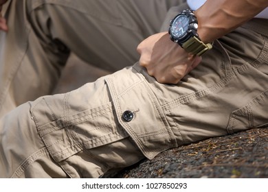 Man Wearing Brown Cargo Pants And Sitting In The Nature Park