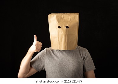 Man Wearing A Brown Paper Bag Over His Head And Giving A Thumbs Up.