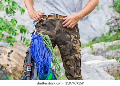 Man Wearing Cargo Pants And Climbing On The Rock