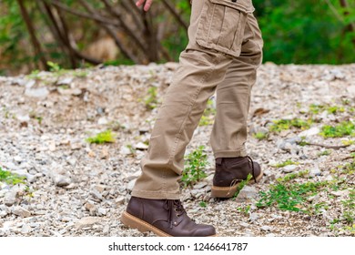 Man Wearing Cargo Pants And Climbing On The Rock