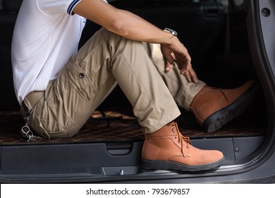 Man Wearing Cargo Pants Sitting In Suv Car Parking In The Nature Park