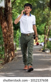 Man Wearing Cargo Pants Standing In The Nature Park