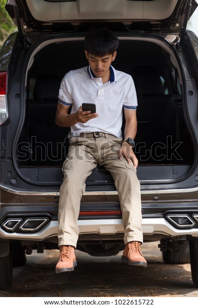 Man wearing cargo pants with suv car parking in the
nature park