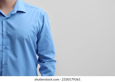 Man wearing clean shirt on white background, closeup. Space for text - Powered by Shutterstock