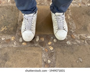 A Man Wearing A Dirty White Shoes