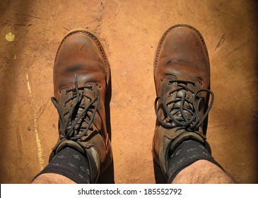 A Man Wearing Dusty Work Boots In The Outback