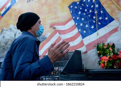A man wearing a face mask prays in front of a mural outside Our Lady of Guadalupe Chapel in Los Angeles, Thursday, Nov. 26, 2020. 