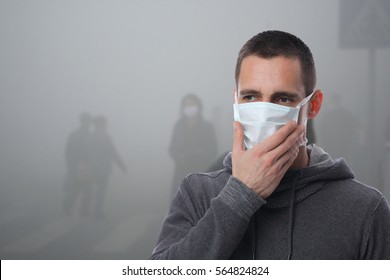 Man wearing facial hygienic mask outdoors. Virus protection ,Ecology, Air pollution, Environmental Awareness concept - Powered by Shutterstock