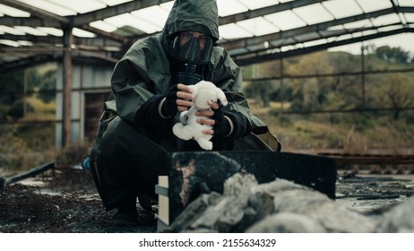 Man Wearing A Gas Mask Finds A Stuffed Animal In A War-torn Hospital