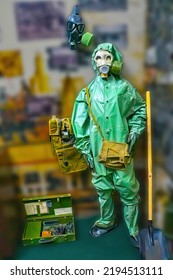 Man Wearing Gas Mask  And Radiation Protection Suit Standing Infront Of Factory. Background Out Of Focus